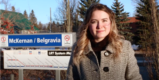 Allie stands in front of the McKernan/Belgravia sign on the Edmonton LRT line.